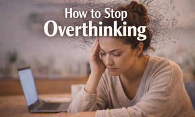 Woman overthinking at desk with laptop and messy thoughts illustration.